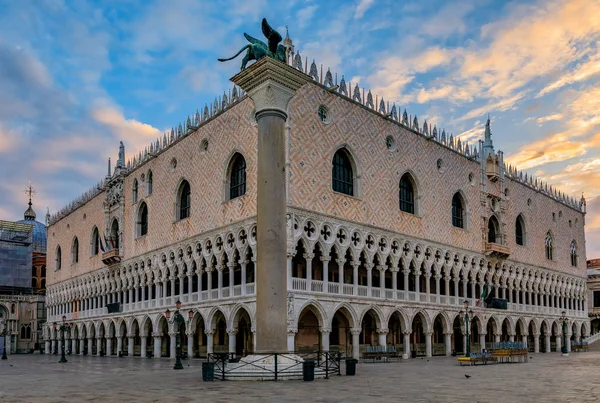View of the Doge\'s Palace and Saint Mark column (the column of the Lion) at Saint Mark\'s (San Marco) square along the Grand Canal in Venice, Italy at sunrise