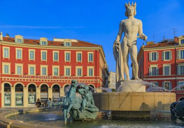Nice, France - April 19, 2016: Famous fountain du Soleil with Alfred Auguste statue of Apollo on Place Massena in Nice on the French Riviera at sunset