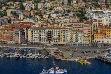 Nice, France - May 25, 2019: View of boats, coastline and traditional houses in Lympia port on the Mediterranean Sea, Cote d'Azur in Nice, France