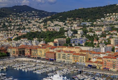 Nice, France - May 25, 2019: View of boats, coastline and traditional houses in Lympia port on the Mediterranean Sea, Cote d'Azur in Nice, France