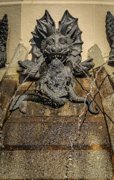 Close up details of the Fountain of the Fallen Angel or Fuente del Angel Caido in the Buen Retiro Park in Madrid, Spain inaugurated in 1885