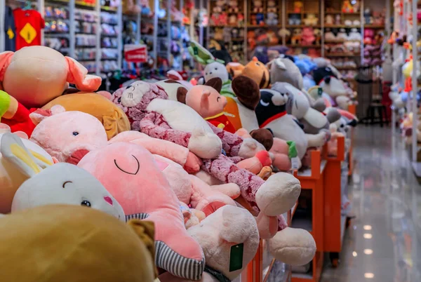Large soft stuffed plush toys in bins and on shelves on display for sale at a toy store in Chinatown Singapore — Stock Photo, Image
