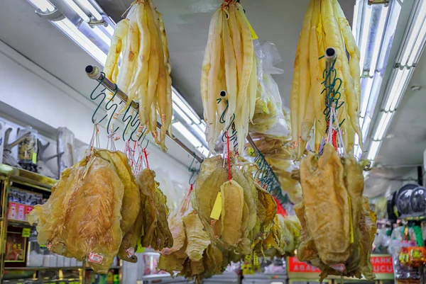 Dried fish stomach or fish maw with price tags hanging at a traditional Chinese food store in Chinatown Singapore — Stock Photo, Image