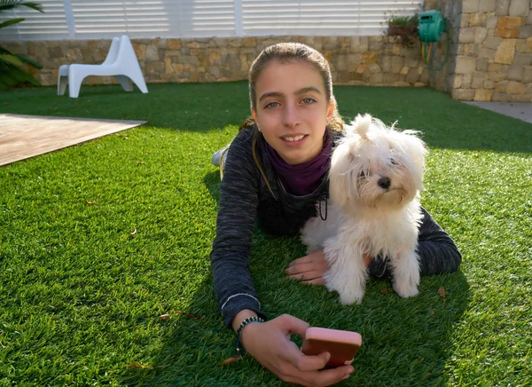 Teenager girl with mobile phone and doggy — Stock Photo, Image