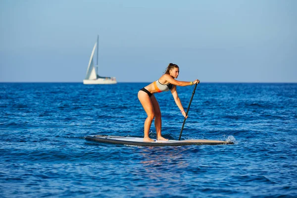 Stand Surf kız raket ile sup. — Stok fotoğraf
