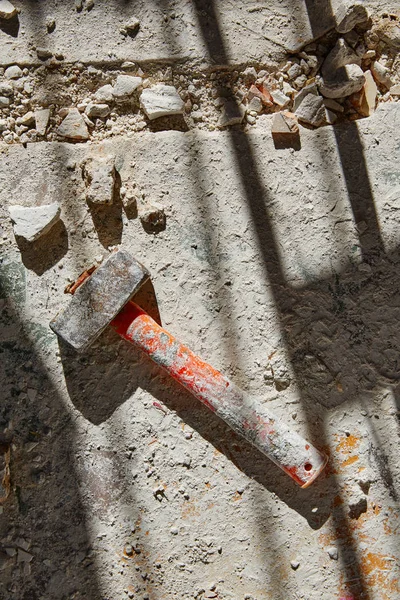 Mason vintage hammer tool on debris — Stock Photo, Image