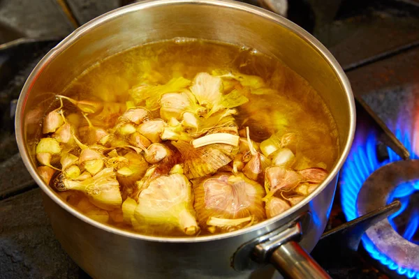 Garlic boiling soup in a pan — Stock Photo, Image