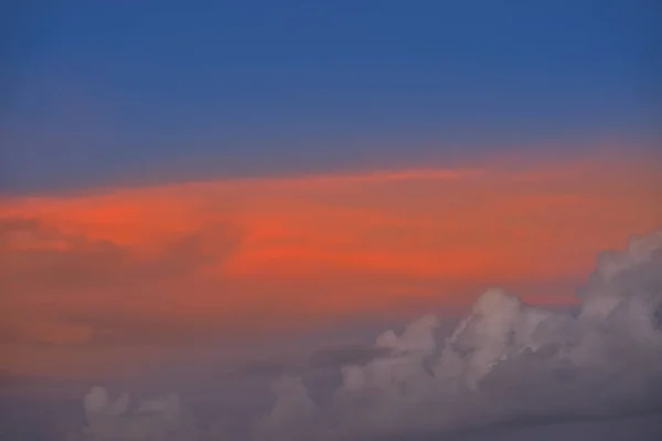 Sunset sky orange clouds on blue — Stock Photo, Image