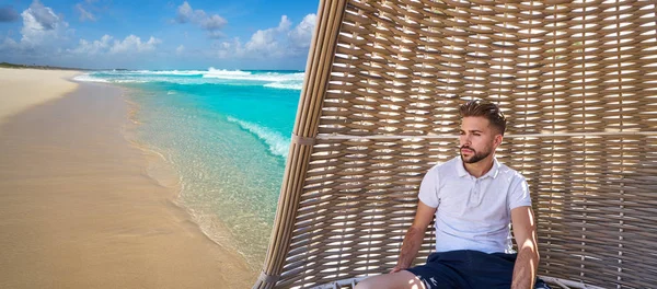 Jonge baard man in parasol op tropisch strand — Stockfoto