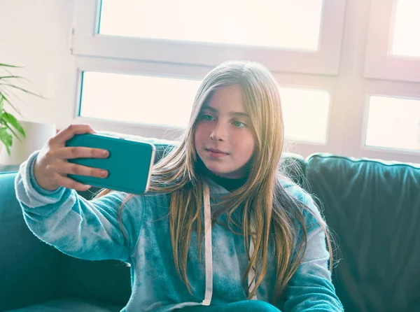 Menina loira selfie com uma janela de fundo — Fotografia de Stock