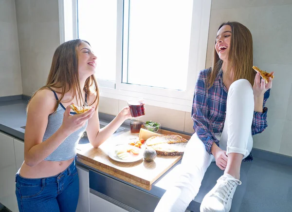 Melhor amigo meninas comer pizza na cozinha — Fotografia de Stock