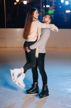 Date lovers in winter rink skates. Concept of Christmas holidays, caring for your loved one.