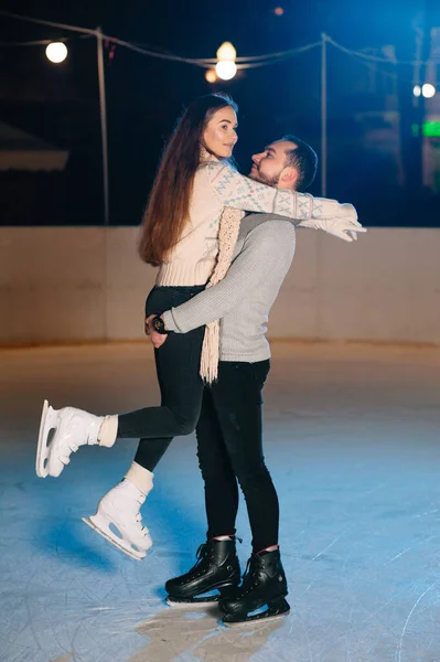 Date lovers in winter rink skates. Concept of Christmas holidays, caring for your loved one.