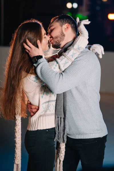 Date lovers in winter rink skates. Concept of Christmas holidays, caring for your loved one.