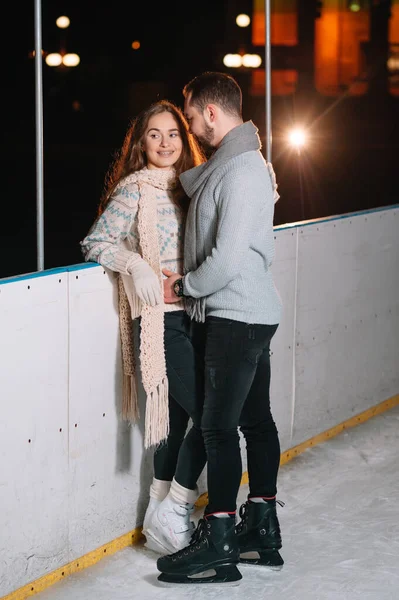 Date lovers in winter rink skates. Concept of Christmas holidays, caring for your loved one.