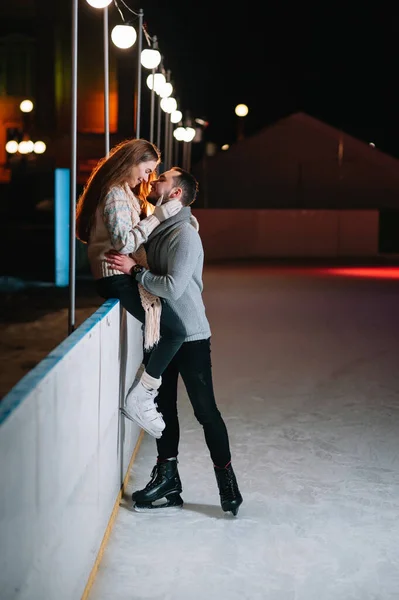 Date lovers in winter rink skates. Concept of Christmas holidays, caring for your loved one.