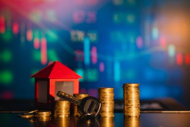 Bir yığın bozuk para ev olarak gölge düşürüyor, tasarruf kavramı.