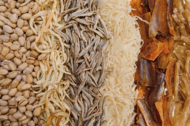 Bira bardaklarının yanındaki tahta kesme tahtasındaki bira atıştırmalıkları gibi bir sürü kurutulmuş balık ve mürekkep balığını kapat. Yiyecek ve içecek konsepti