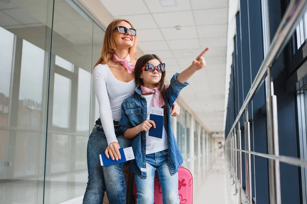 飛行機を待ってる空港の娘とママ窓の外を見て ハイシーズンと休暇のコンセプト リラックスしてライフスタイル — ストック写真