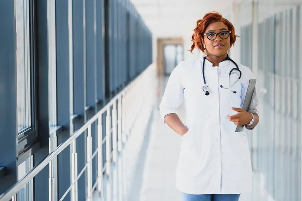 portrait of pretty african medical doctor. african american doctor in modern clinic