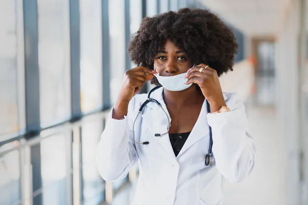 Young attractive african doctor with face mask