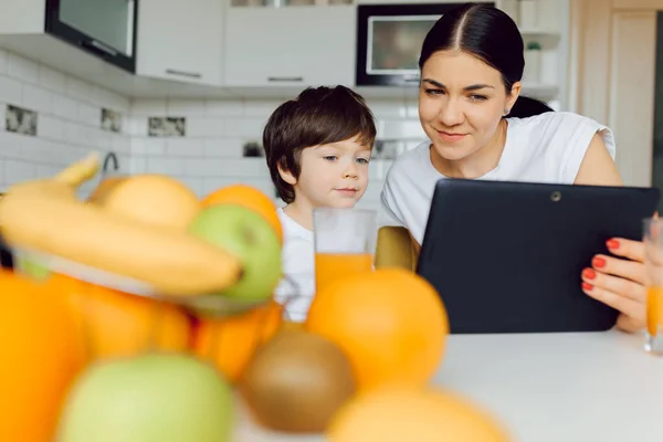 Happy family using a tablet pc in kitchen