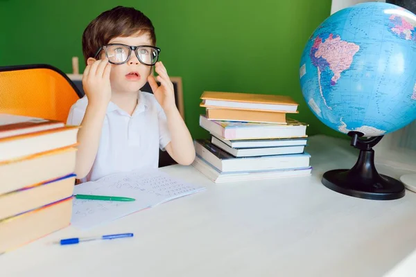 Kid in Self isolation doing his mathematics homework while school off,Child learning math at home during covid lock down,Home schooling and concept of COVID-19 pandemic infection. Social Distancing