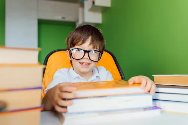 Stay at home, online learning, distance learning, self quarantine concept. Boy start doing homework with books notebooks for lesson at home