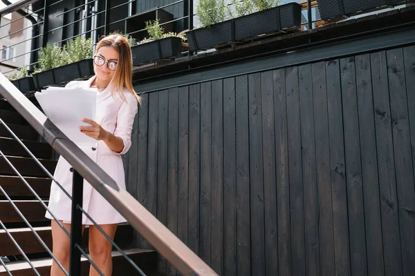 Portrait of business woman walking and smiling outdoor