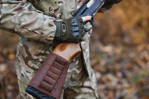 Hunter handsome guy with weapon. Hunter spend leisure hunting. Hunting equipment. Brutal masculine hobby. Man observing nature background. Hunter hold rifle. Safety measures. Natural environment.