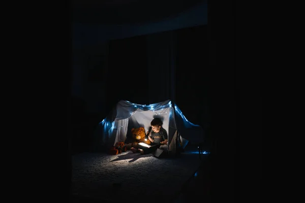 Child Boy Reading Book Flashlight Teddy Bear Tent Going Bed — Stock Photo, Image