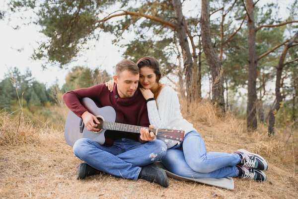 Beautiful young couple walking in autumn park