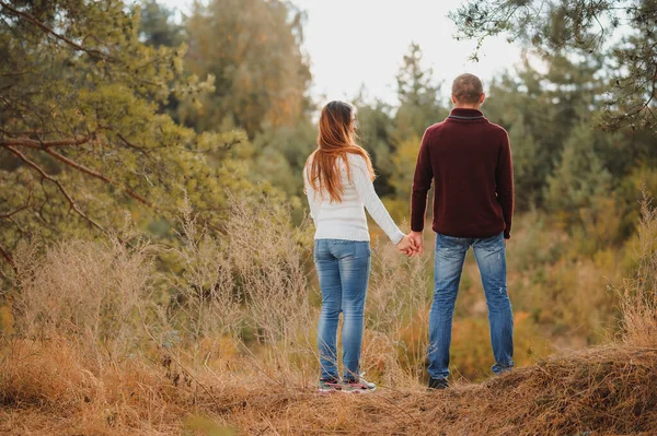 美丽的年轻夫妇在秋天的公园里散步 — 图库照片