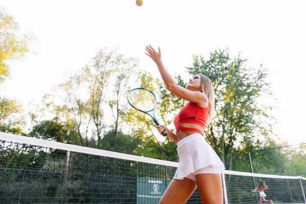 girl tennis player is training on the court