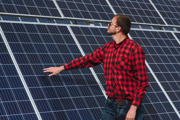 solar panels. Man standing near solar panels