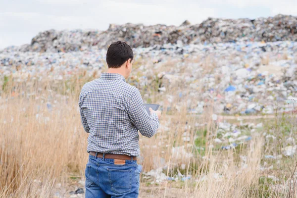 Nature conservation concept. A man studies the pollution of nature. Keeping the environment clean. Ecological problems. Recycling