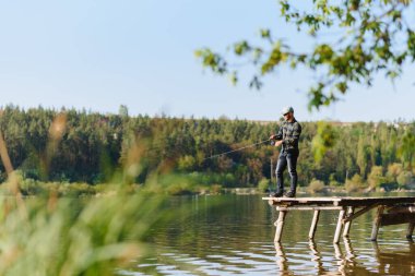 Yazın balık tutan bir adam balık tutar.