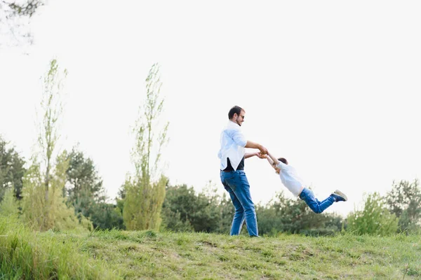 Happy time with father. Family fun concept. Bearded man and cute son Kids smile. Spring time walk with father.