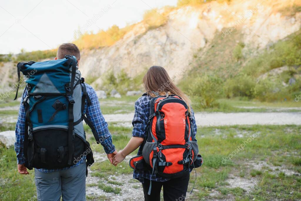 happy young couple hiking in mountain