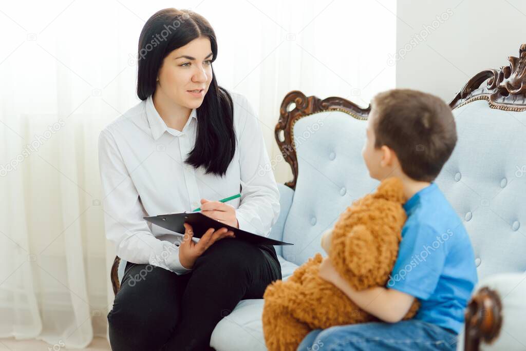 Child psychologist attending small boy. The concept of psychological assistance to children.