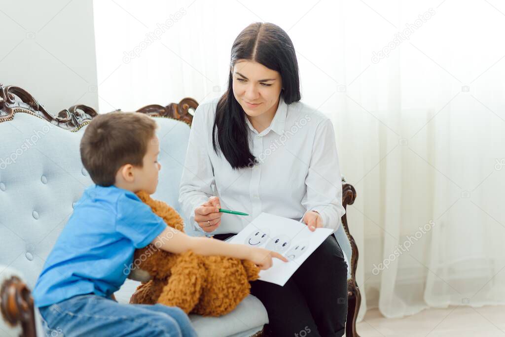 Picture of child psychologist working with young boy in office