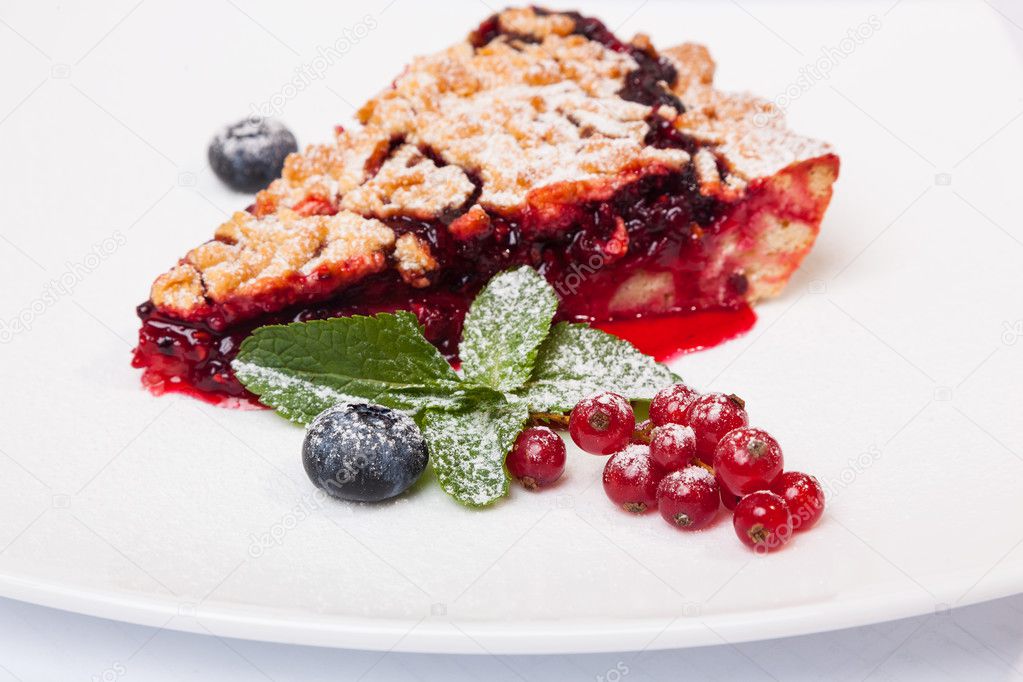 Sandy dough cake with jam and berries on plate