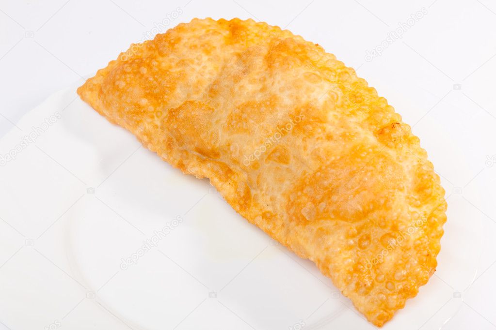 one cheburek with lamb on white plate