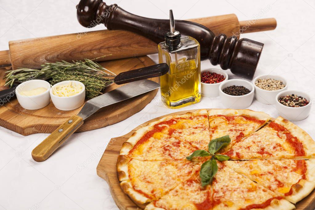 still life with Pizza and cookware on white background