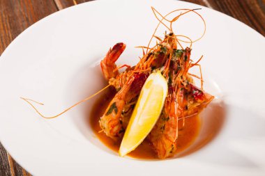 Beyaz tabakta limonlu kaplan karidesi