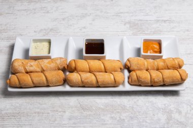 Tequenos adında, peynirle dolu kızarmış mısırdan yapılmış Latin Amerika mezeleri.