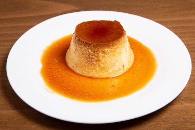 Kremalı karamel, flan veya beyaz tabakta tatlı şuruplu karamel pudingi. Ev yapımı muhallebi.