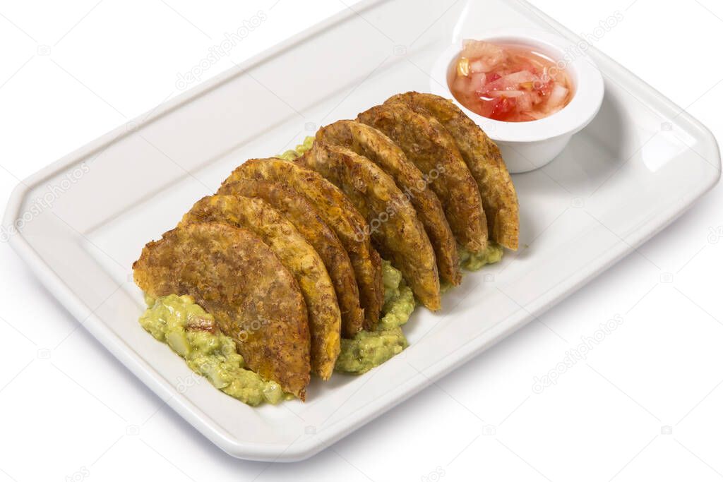 Venezuelan food: patacon with guacamole on a white plate