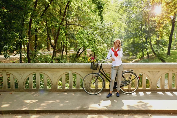 Cheerful woman with bicycle — Stock Photo, Image