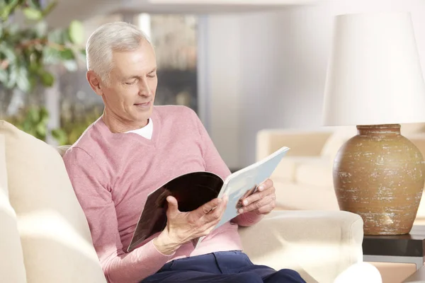 senior man reading a magazine